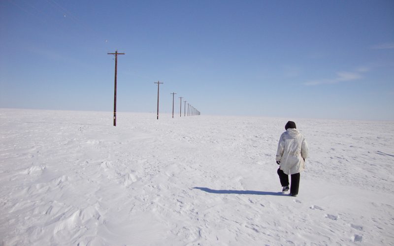 Arctic researcher walking in snow.